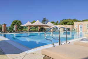 a large swimming pool with chairs and umbrellas at Thurlestone Hotel in Thurlestone