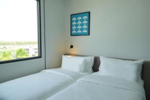 Postel nebo postele na pokoji v ubytování GO! Hotel Chonburi at Central Chonburi