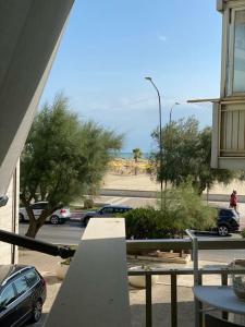 a view of a street with cars parked on the road at Appartamento Fronte Mare con ombrellone e sedie sdraio incluse nel costo in Pescara