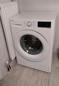 a white washing machine sitting in a room at FoRest & sea view apartment in Argostoli