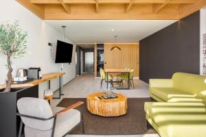 a living room with a couch and a table at AP Eva Senses in Faro