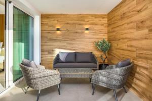 a patio with two chairs and a couch at AP Eva Senses in Faro