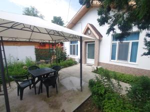a patio with a table and chairs under an umbrella at GUEST APRTMENT FOR STAY in Vidin