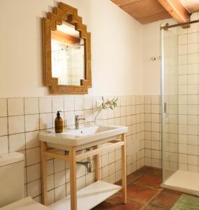 a bathroom with a sink and a mirror at The Wild Olive Andalucía Palma Guestroom in Casares