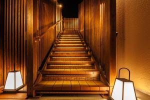 a staircase in a building with two lights at Hotel Kan-ichi in Atami