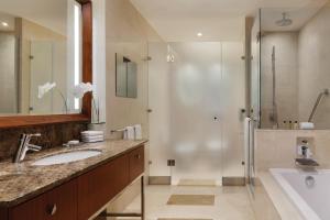 a bathroom with a sink and a shower at JW Marriott Marquis City Center Doha in Doha
