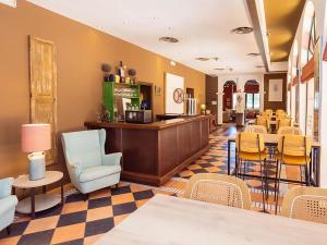 a waiting room with chairs and a counter in a store at Isla Canela Golf Hotel Boutique in Isla Canela