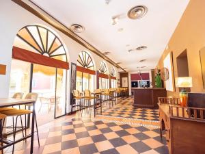 a restaurant with a checkered floor and tables and chairs at Isla Canela Golf Hotel Boutique in Isla Canela