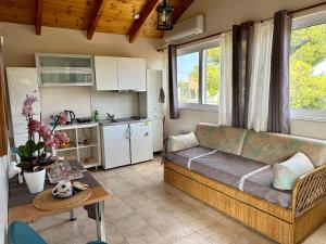 a living room with a couch and a table at Thanos Studio in Artemida