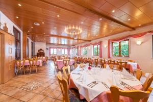 a banquet hall with tables and chairs in it at Tonis Tenne in Eschbach