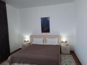 a bedroom with a large bed with two night stands at Апарт отель Welcome in Taldykorgan