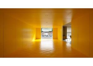 an empty room with yellow walls and a hallway at The Brunei Hotel in Bandar Seri Begawan
