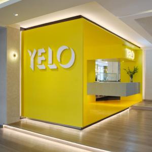 a yellow wall with the xo logo on it at The Brunei Hotel in Bandar Seri Begawan