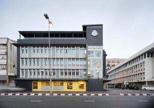 a building with a clock on the side of it at The Brunei Hotel in Bandar Seri Begawan