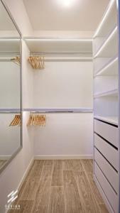 a walk in closet with white cabinets and a mirror at Roissy, CDG, Paris, Disney, Astérix in Gonesse