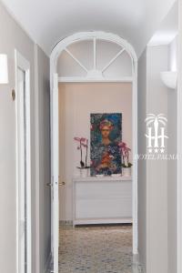 un arco que conduce a un pasillo con una pintura en Hotel Palma en Castellammare di Stabia