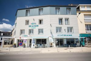 a large white building on the side of a street at Hôtel de la Baie in Crozon