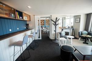 a bar with chairs and tables in a restaurant at Hôtel de la Baie in Crozon