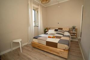 a bedroom with a bed with a bowl of fruit on it at La Maison del lago in Capodimonte +14 photos
