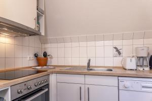 a kitchen with a sink and a counter top at 50171 Haus Antje I in Harlesiel