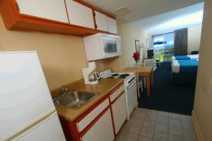 a kitchen with a sink and a kitchen with a living room at Bar Harbor in Myrtle Beach