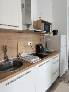a kitchen with a sink and a microwave at Beach Pearl in Bečići