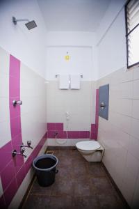 a bathroom with a toilet and a sink at VKG Hotels in Puducherry