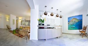 a large living room with a table and chairs at Kalidon beach Hotel in Kokkari