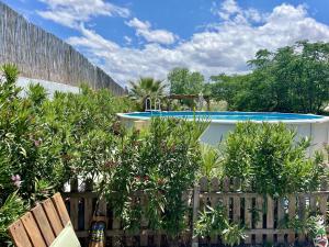 a backyard with a swimming pool and trees and a fence at Boutique Teepee Sleeps 2 with Pool in Zújar