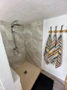 a bathroom with a shower and a towel hanging on a wall at Boutique Teepee Sleeps 2 with Pool in Zújar