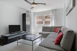 a living room with a couch and a tv at Medano Beach Home Ocean View in El Médano