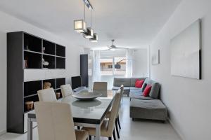a dining room and living room with a table and chairs at Medano Beach Home Ocean View in El Médano