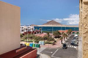 a view of a street with a mountain in the background at Medano Beach Home Ocean View in El Médano