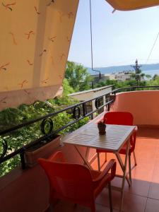 a table and chairs on a balcony with a view at Villa Edi in Vlorë