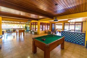 a pool table in the middle of a room at Apart Hotel Boulevard da Praia - Portal Hotéis in Porto Seguro
