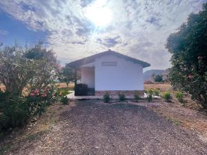 a small white building in the middle of a field at Casetta Madre Vita in Belvedere
