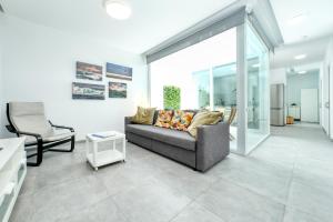 a living room with a couch and a chair at Karma Famara 2 25m del mar in Famara