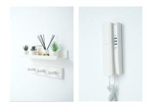 a kitchen with a refrigerator and a shelf with plants at Karma Famara 2 25m del mar in Famara