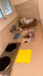 a kitchen counter with two sinks and yellow sticky notes at Elias Basilica Rooftop Penthouse in Nazareth
