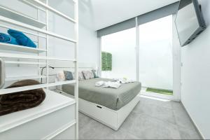 a bedroom with a bed and a window at Karma Famara 2 25m del mar in Famara