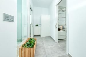 a bathroom with white walls and a wooden box on the floor at Karma Famara 2 25m del mar in Famara