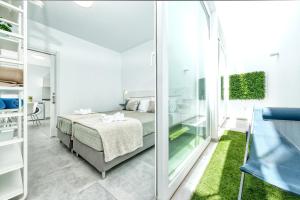 a bedroom with a bed and a glass wall at Karma Famara 2 25m del mar in Famara