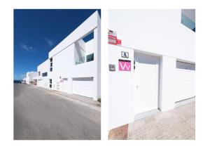 a white building with a door and a street at Karma Famara 2 25m del mar in Famara
