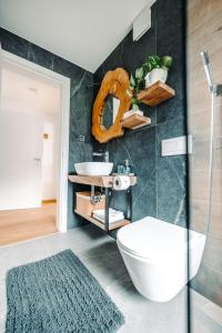 a bathroom with a white tub and a sink at Goat's Paradise in Bohinj