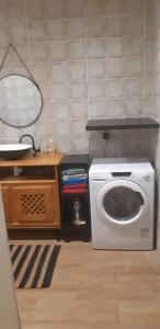a laundry room with a washing machine and a table at Villa Ty an heol in Ngaparou