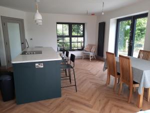 a kitchen and living room with a table and chairs at Corradiller Quay, Lisnaskea, Fermanagh in Lisnaskea