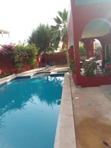 a swimming pool in front of a house at Villa Ty an heol in Ngaparou