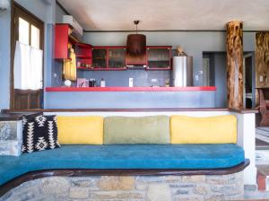 a blue and yellow couch in a living room at Maria's House in Zagora