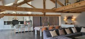 a living room with a couch and a table at Domaine De L'aube Des Temps in Raissac-dʼAude
