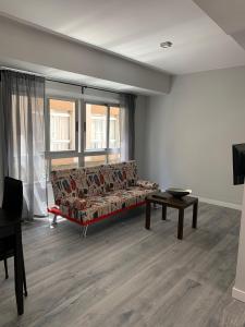 a living room with a couch and a table at Apartamento playa sada in Sada